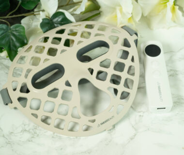 A Faradbeauty Luxe Halo LED Mask lying on a marbled surface